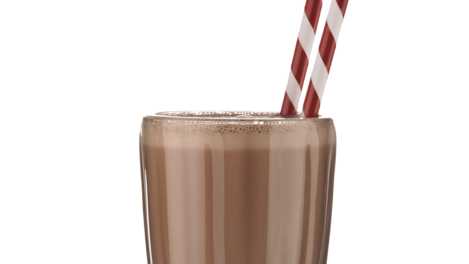 Classic glass of chocolate milkshake on white backdrop.